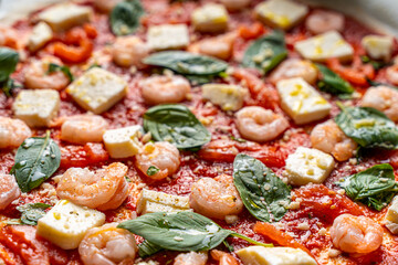 Juicy three burgers with beef patty, tomatoes, onions and lettuce on baking paper. on a light background