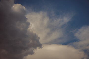 White heap clouds in the blue peaceful sky. The concept of psychological calmness and health. Peace of mind with the forces of nature. Air travel concept.