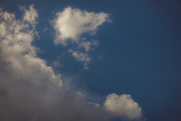 White heap clouds in the blue peaceful sky. The concept of psychological calmness and health. Peace of mind with the forces of nature. Air travel concept.