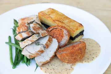Pan fried pork fillet with black pudding dauphinoise potatoes and mustard sauce 