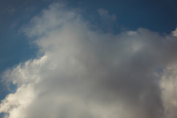 White heap clouds in the blue peaceful sky. The concept of psychological calmness and health. Peace of mind with the forces of nature. Air travel concept.