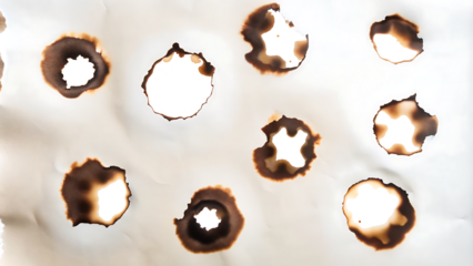 Collection of burnt holes in piece of paper isolated on white background.AI GENERATED