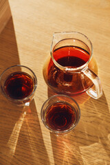 Morning Coffee Serving With Glass Carafe on Wooden Table, Casting Warm Shadows in Soft Natural Light