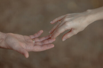 A couple in love touches each other with their hands. Love story of a young couple in love. Wedding...
