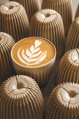 Top View of Cappuccino With Intricate Latte Art Surrounded by Cups 