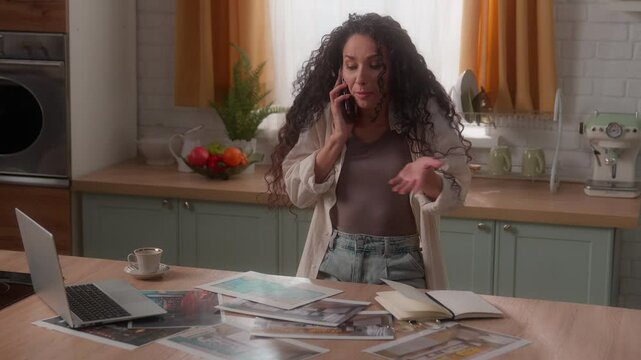 Stressed angry Hispanic designer woman Latina girl female homeowner at home kitchen problem talking mobile phone argue quarrel discuss trouble templates pictures photos interior renovation design