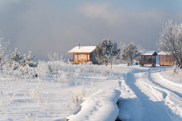 Winter fishing houses or hut on the river on a cold foggy morning, Russia Siberia