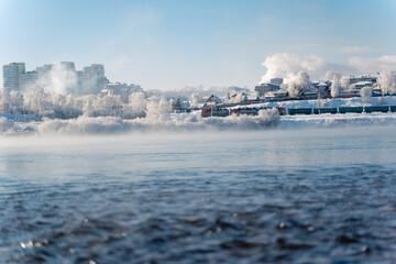 Winter frosty evaporation from the river in cold weather.