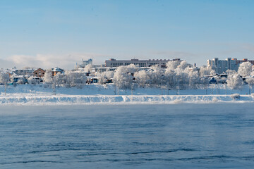 Winter frosty evaporation from the river in cold weather.