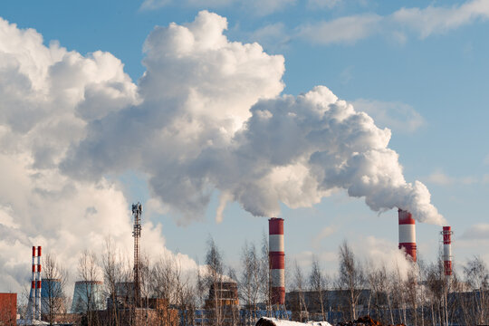 Emissions of harmful substances into the atmosphere. Air pollution from heating station a natural gas and coal power plant. Ecological concept.