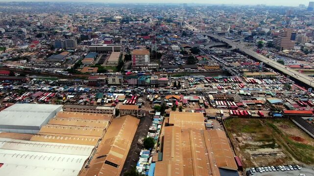 Drone shot of industrial buildings and a busy congested market area with a lorry parking  in Accra, capital of Ghana.  Beautiful and crowded urban landscape in Africa. 