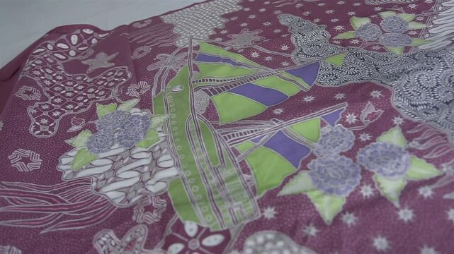 the intricate process of making hand-written batik, which showcases traditional techniques and art in bright, detailed patterns.