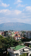 Obraz premium Tirana Cityscape with Majestic Mountain Backdrop