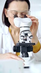 Woman scientist using microscope in laboratory. Microbiology science concept