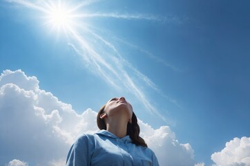 Caucasian woman in blue hoodie gazing at sun blue sky evoking hope and optimism