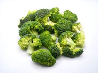 Top view of chopped broccoli on a white background. Fresh vegetable for a diet. Green vegetable