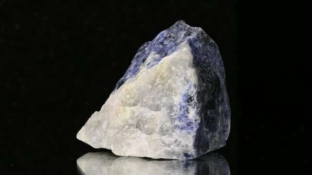 Sodalite (Sodium aluminium silicate) sample rotating slowly against a black background [Madagascar]