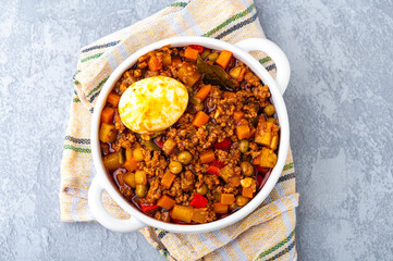 Filipino-style Picadillo with ground meat, potatoes, carrots, green peas, bell peppers and boiled egg on the side.
