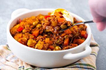 Filipino-style Picadillo with ground meat, potatoes, carrots, green peas, bell peppers and boiled egg on the side.