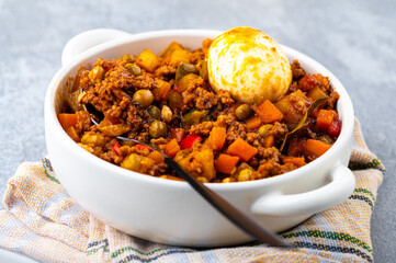Filipino-style Picadillo with ground meat, potatoes, carrots, green peas, bell peppers and boiled egg on the side.