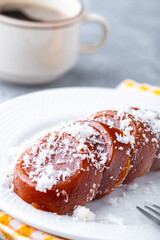 Pinoy puto kutsinta, is a type of steamed rice cake popular as street snack or merienda. It is made from a blend of rice or tapioca flour, brown sugar, and lye, giving it its distinct chewy texture.