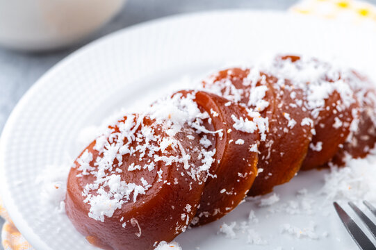 Pinoy puto kutsinta, is a type of steamed rice cake popular as street snack or merienda. It is made from a blend of rice or tapioca flour, brown sugar, and lye, giving it its distinct chewy texture.