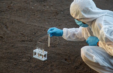 Soil analysis in a test tube. Selective focus.