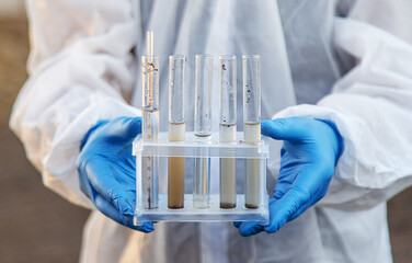 Soil analysis in a test tube. Selective focus.