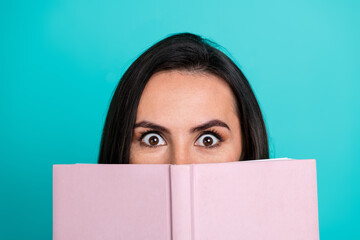 Photo of cheerful pretty lady enjoy interesting scary book empty space isolated blue color background