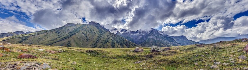 Scenic view of the Cross Pass in Georgia, showcasing lush green mountains and a winding valley