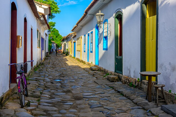 Street with tables of cafe in historical center in Paraty, Rio de Janeiro, Brazil. Paraty is a preserved Portuguese colonial and Brazilian Imperial municipality