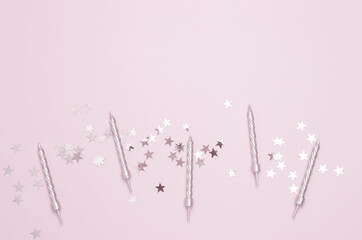 Blank card surrounded by confetti and candle. Concept of festive birthday celebrations