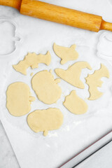 Making different shapes of fall cookies for Halloween. Dough with cookie cutter