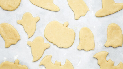 Making different shapes of fall cookies for Halloween. Dough with cookie cutter