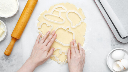 Making different shapes of fall cookies for Halloween. Dough with cookie cutter