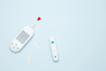 Diabetes concept with glucometer and red drop of blood. Concept of worldwide diabetes awareness