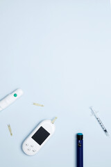 Diabetes concept with glucometer, syringe pen with insulin, blood test strips. Concept of worldwide...