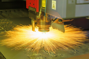 The fiber laser cutting machine cut the metal plate with the sparkling light.
