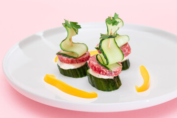 Canapes without Bread with Salami, Cucumber, Greens and Cream Cheese on White Plate. Easy Breakfast. Diet Food. Quick and Healthy Sandwiches. Healthy Snacks with Tasty Fillings