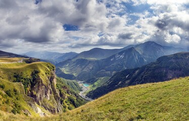Scenic view of the Cross Pass in Georgia, showcasing lush green mountains and a winding valley