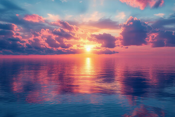 Obraz premium Vibrant sunset over a calm ocean reflecting pink and orange hues