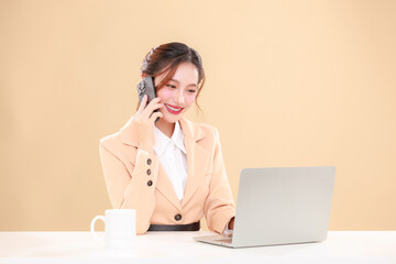 Smiling young Asian business woman leader entrepreneur wearing stylish suit with mug using laptop online applications customer order surround by boxes on isolated background.