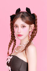 Naklejka premium Gorgeous fashionable Asian woman two side braids in tight trendy dress perfect slim fit body clean fresh skin posing on isolated pink background. Sexy lady good shape model portrait in studio.