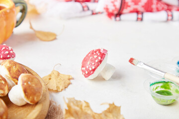 Autumn food creativity, colouring marshmallow mushrooms for kids, no sugar. Background of autumn decorations, handmade goodies