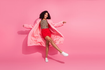 Full body photo of attractive young woman dancing have fun dressed stylish leopard print warm coat clothes isolated on pink background