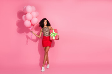 Full body photo of young woman air balloons gift look empty space dressed stylish leopard print clothes isolated on pink color background