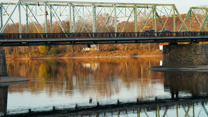One old rion frames bridge view on the river with the sunset sky as background