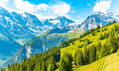 Panorama of Swiss Alps, snow capped mountains and green valley, Switzerland landscape