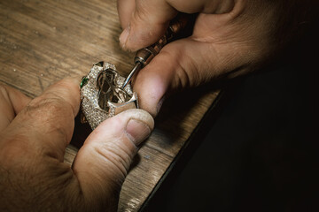 Different goldsmiths tools on the jewelry workplace. Jeweler at work in jewelry. Desktop for craft jewelry making with professional tools. Close up view of tools.