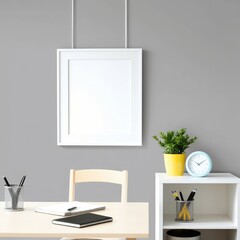 "A simple and bright office room with modern decor. The back wall is painted in light gray, with an empty white picture frame hanging in the middle. Below the frame, there is a light-colored wooden ta